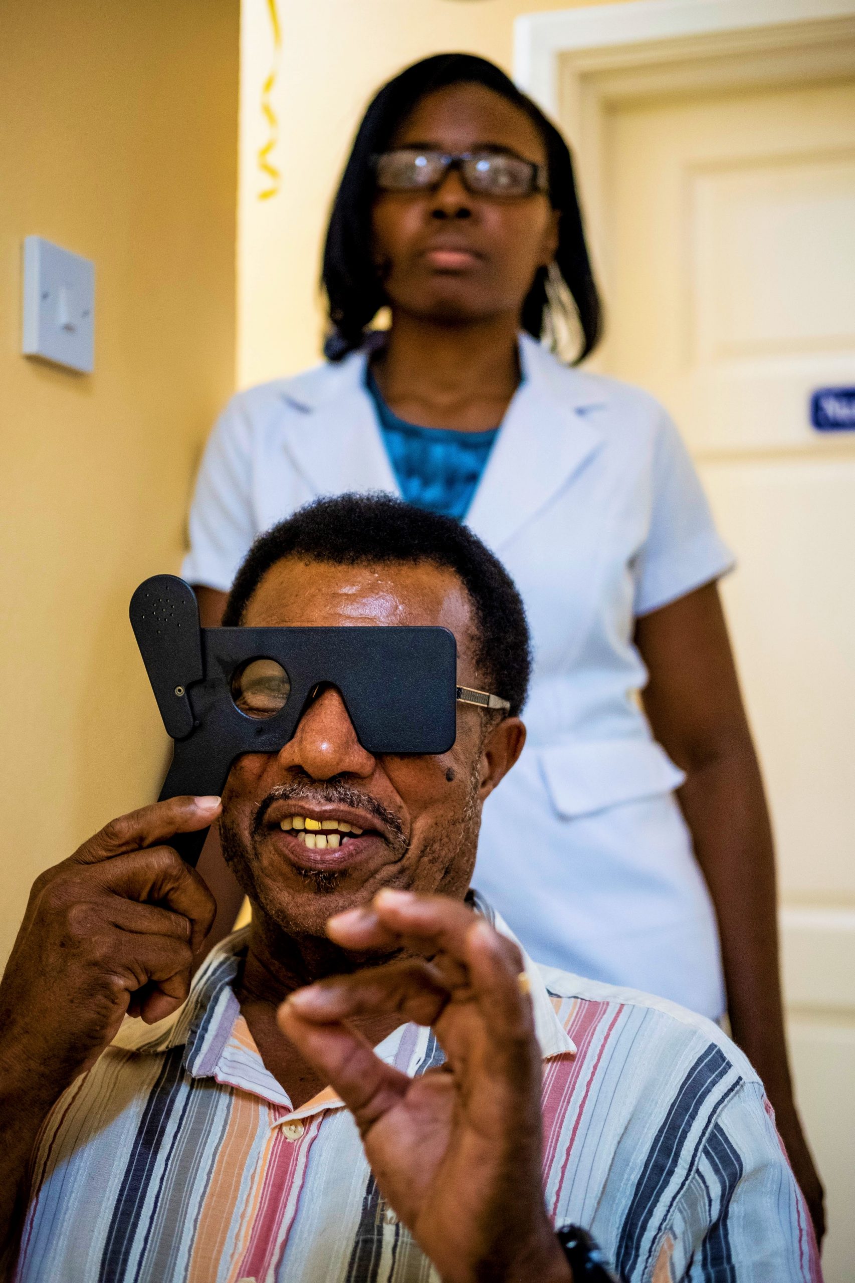 A man in St. Lucia  checks his vision through a portable phoropter