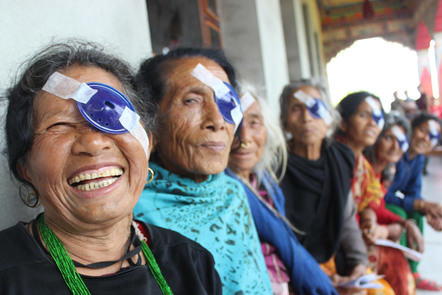 Row of Indian women sitting with eye patches post treatment 