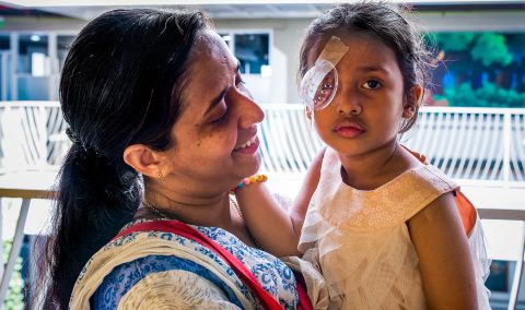 In South Asia, a young girl wears a patch after surgery