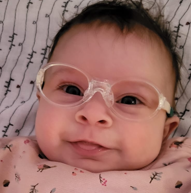 a baby in near vision glasses