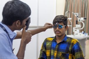 In India a health worker holds training frames up to a man's face