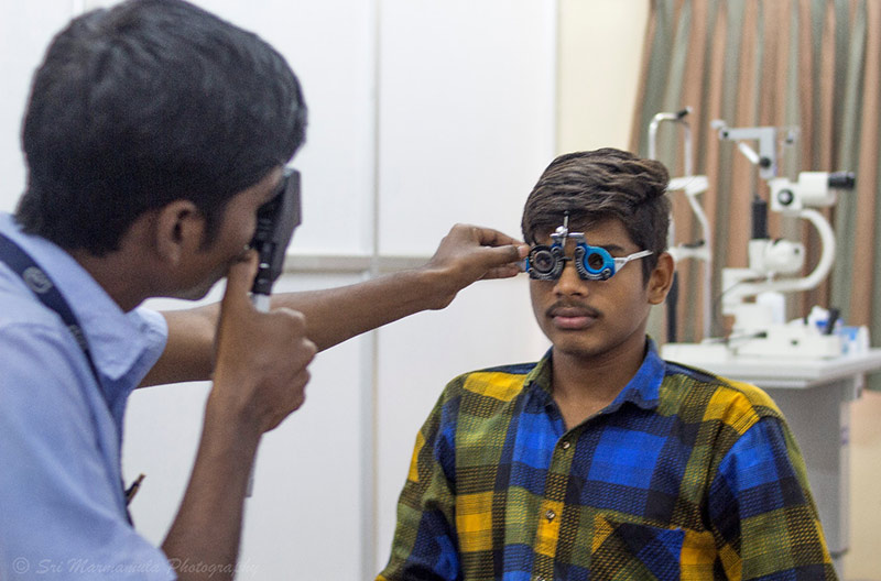 In India a health worker holds training frames up to a man's face