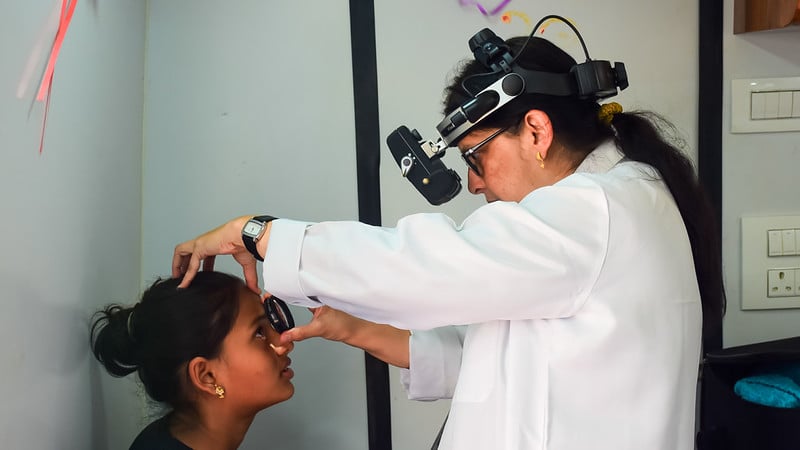 54858828648_453a678484_c In India, a doctor examines a young girls' eye