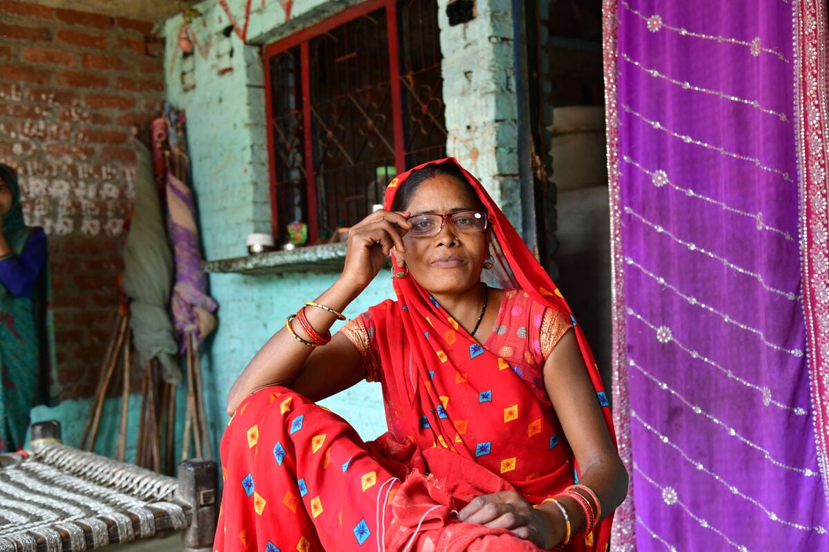 DSC_1613-Medium A woman in a bright Sari wears reading glasses in India
